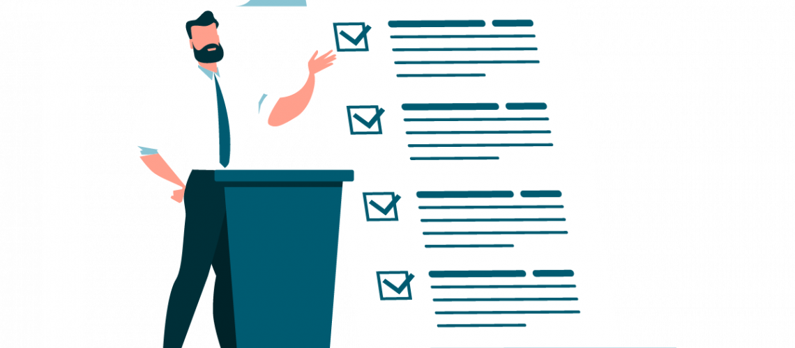 person på en scene som snakker med et ark med punkter ved siden av